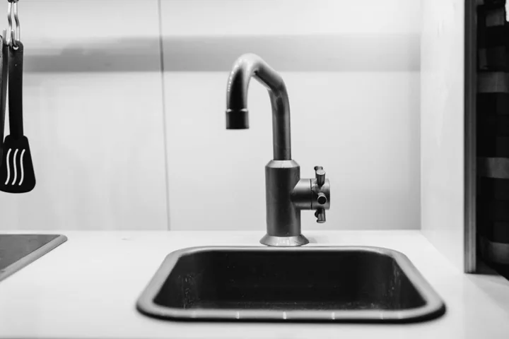 a black and white photo of a kitchen sink