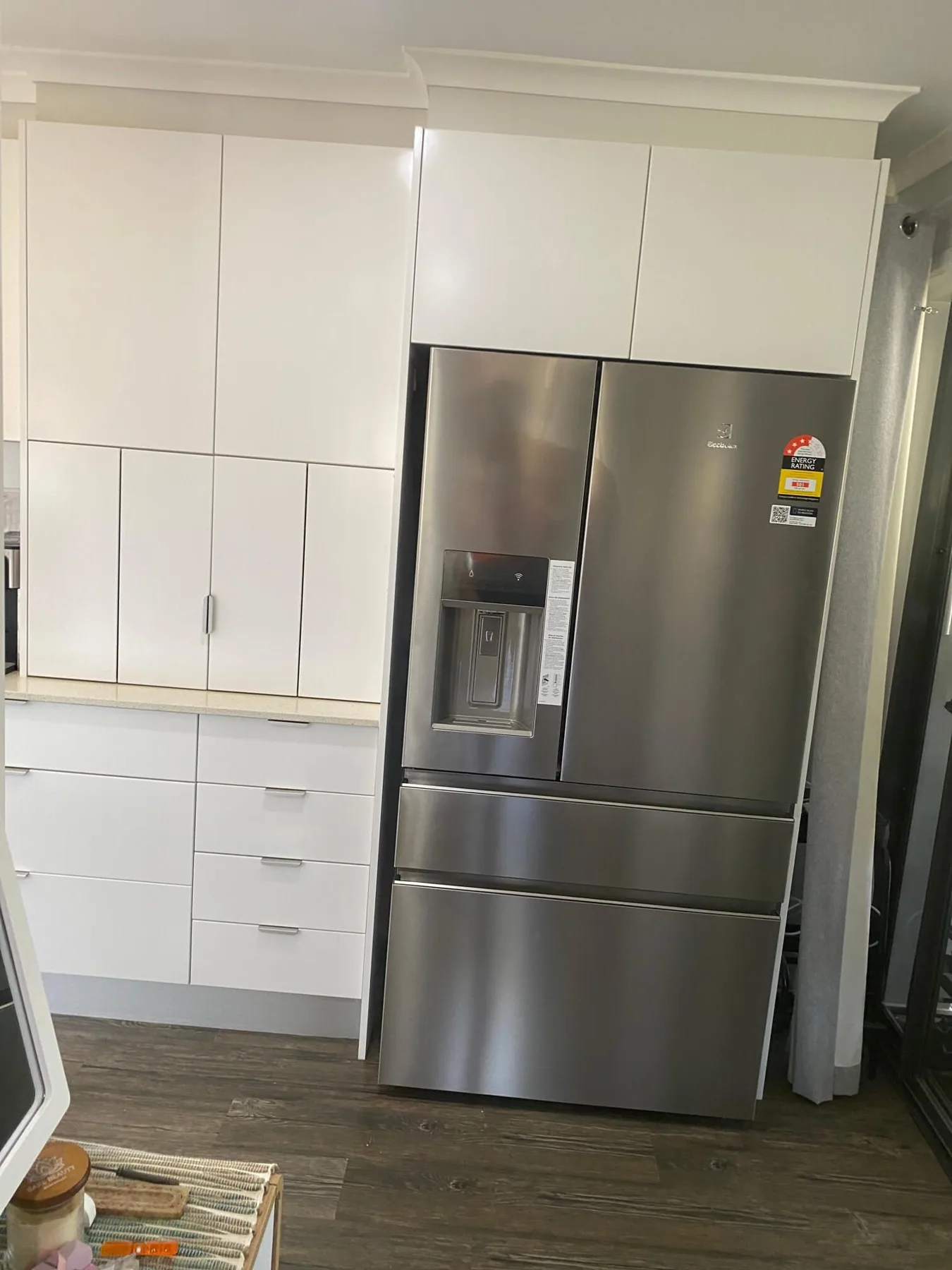 Plumbed fridge with a water dispenser in a fitted kitchen