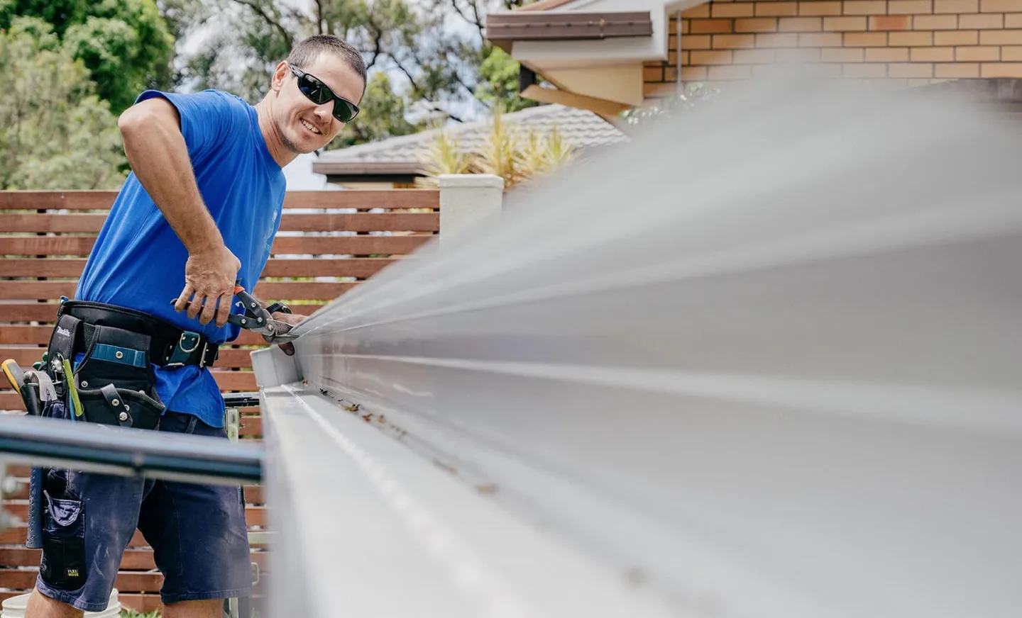 Jetty Plumbing team member working along a roof gutter